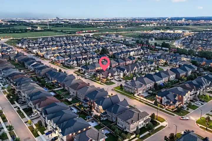 Neighbourhood at dusk from the air, listing marked