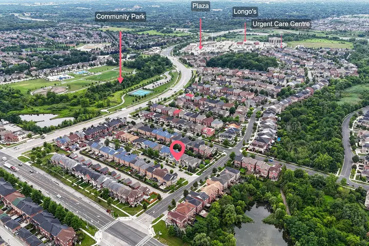 Aerial showing parks and shops near the listing