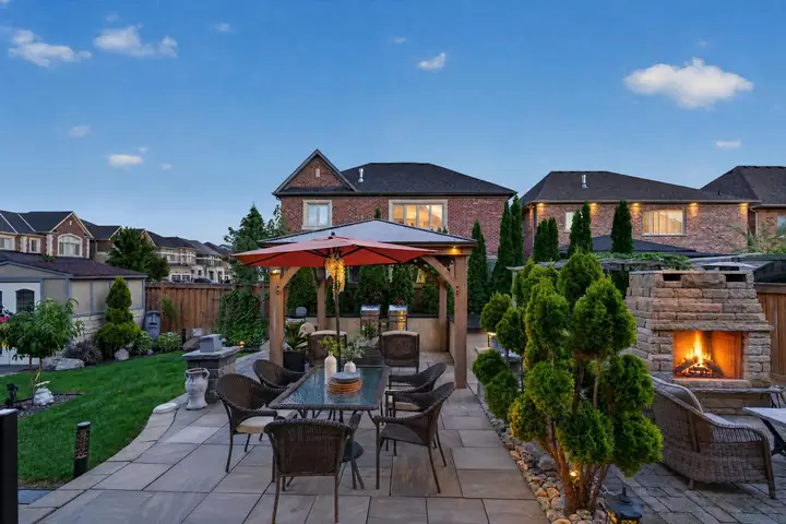 Backyard patio with an outdoor fireplace