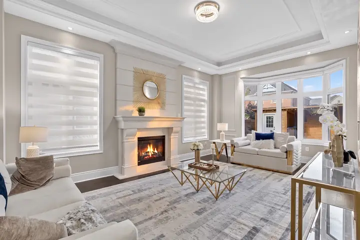 Family room with a fireplace and bay window