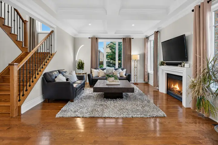 Living room with a fireplace and oak staircase