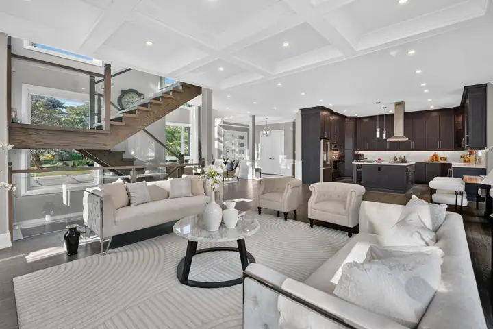 Open-plan living room with a floating staircase