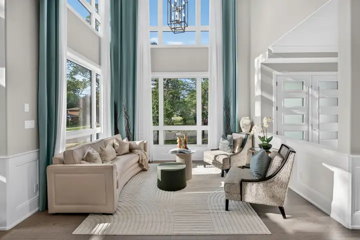 Living room with tall windows and teal drapes