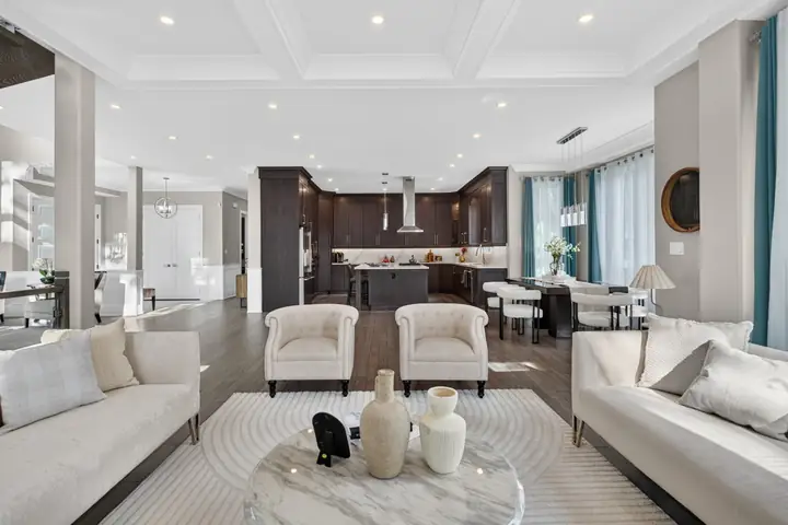 Living room open to a dark wood kitchen