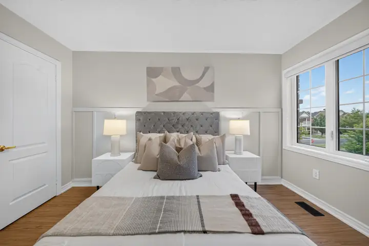 Bedroom with a grey tufted headboard