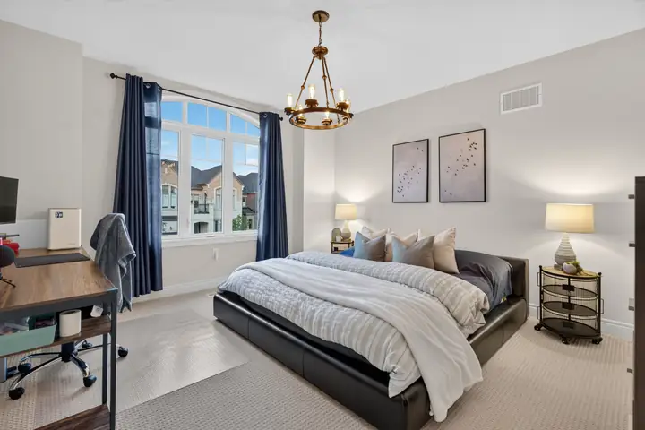 Bedroom with a brass chandelier