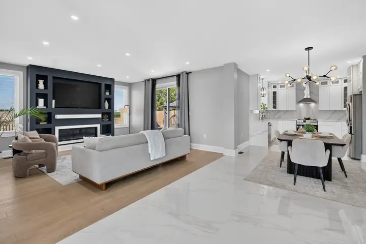 Open living room with a media wall and dining area