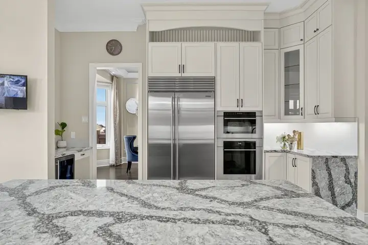 Kitchen with a marble island and built-in fridge