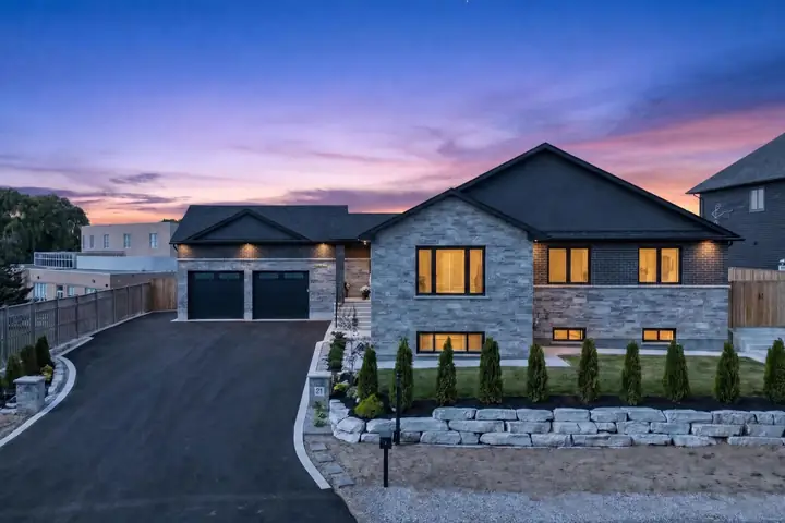 Modern bungalow at dusk with warm window light