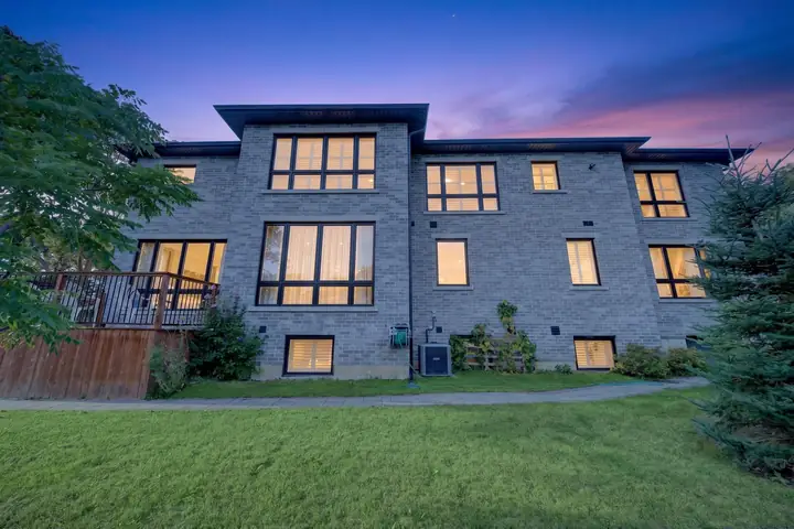 Modern home at dusk, seen from the yard