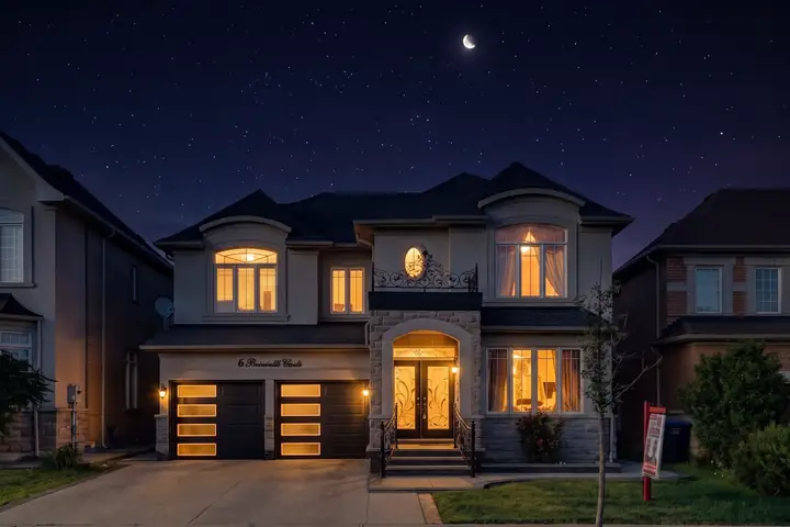 Stone home under a night sky and crescent moon