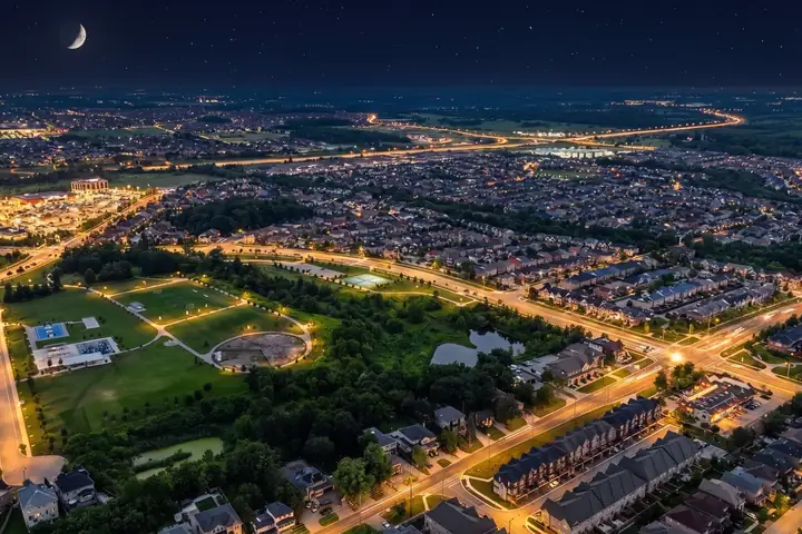 Aerial of a lit neighbourhood at night